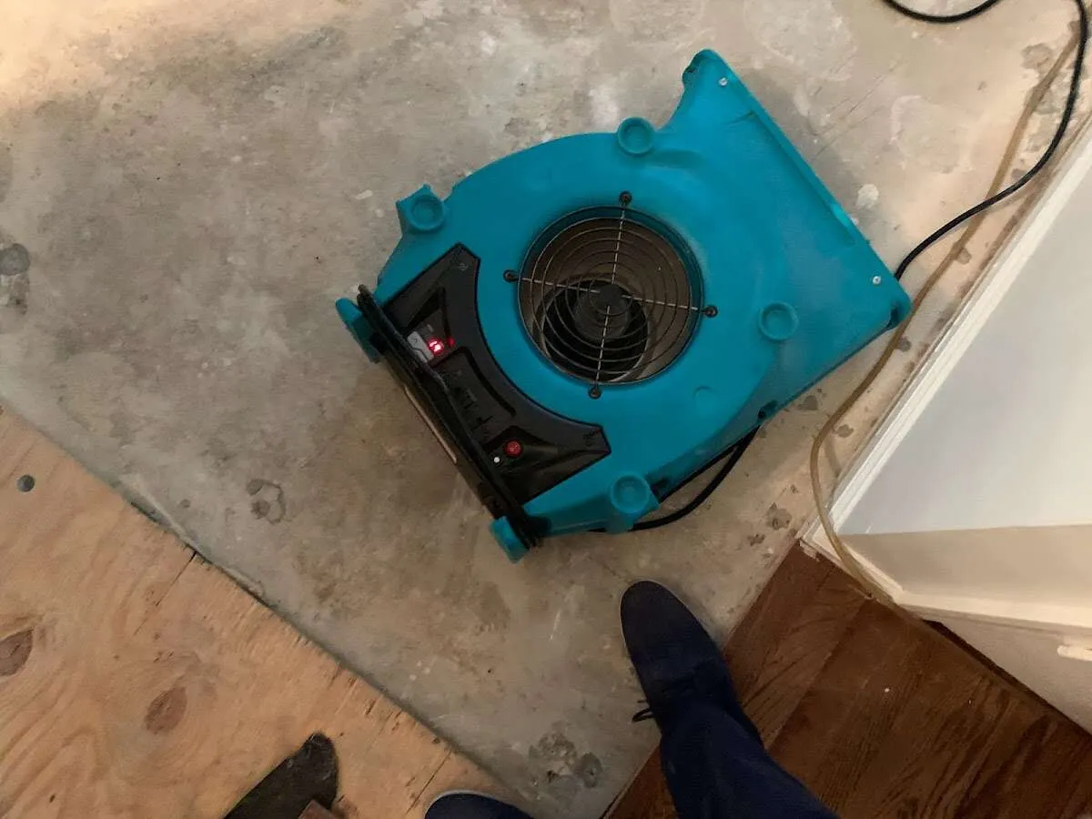 Air mover drying subfloor during Commercial Water Damage Restoration in East Fishkill